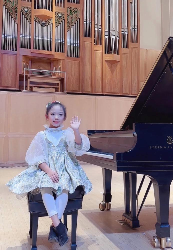 Pianist Natalie Sun at Piano in front of Organ Loft. 