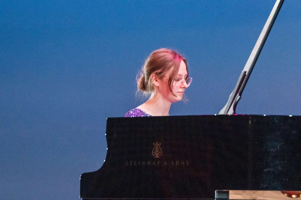 Emily Runov plays at the piano