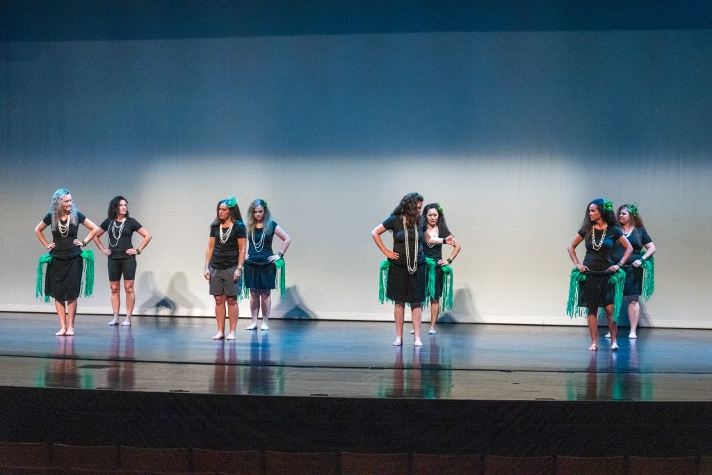Tahitian dancers perform on stage. 